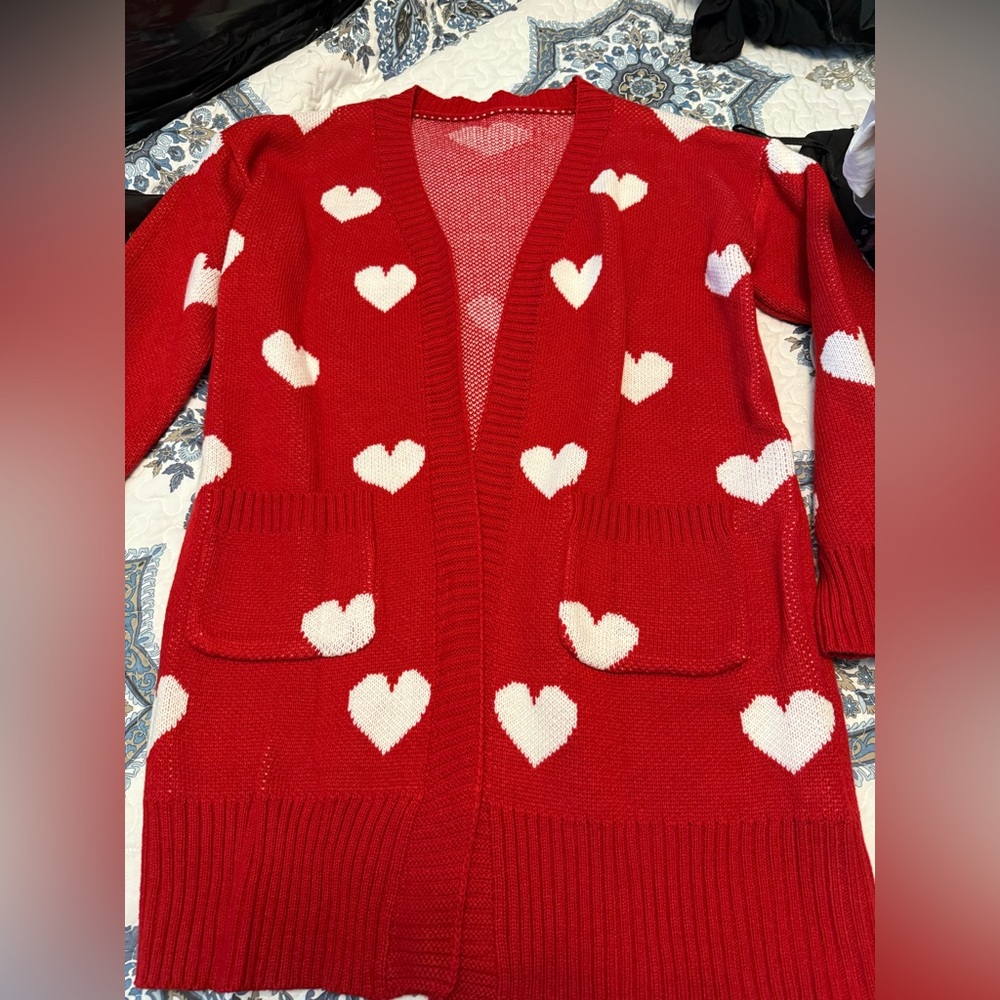 Mid length red cardigan with white hearts. This brand new. No tags. Medium